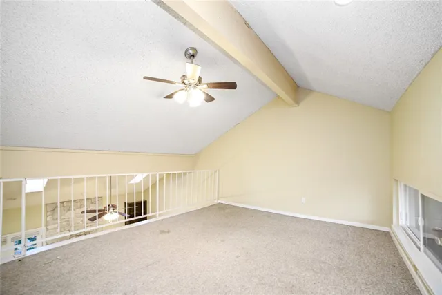 a view of a livingroom with a ceiling fan and window