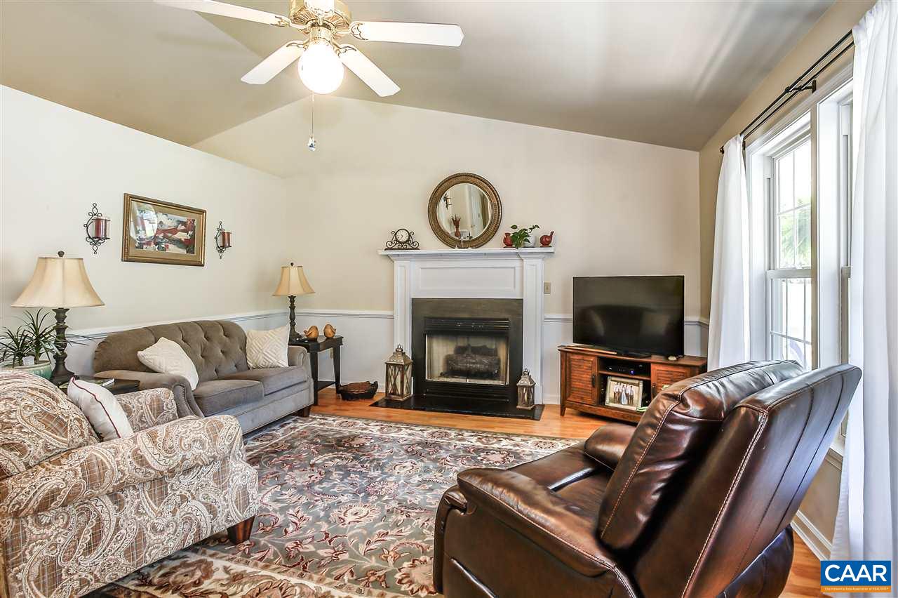 16 Bernardsburg Road Palmyra, VA 22963 - Photo 5 of 24 a living room with furniture a fireplace and a flat screen tv