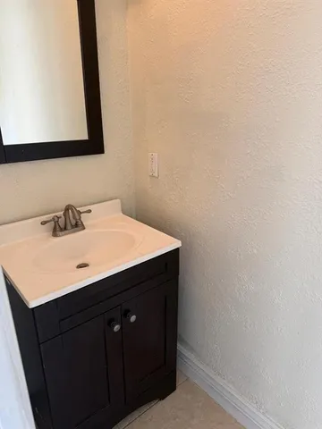 a white toilet sitting next to a shower