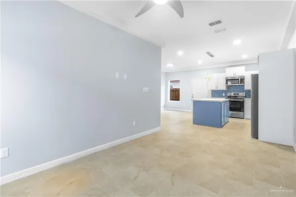 a view of kitchen with stainless steel appliances cabinets