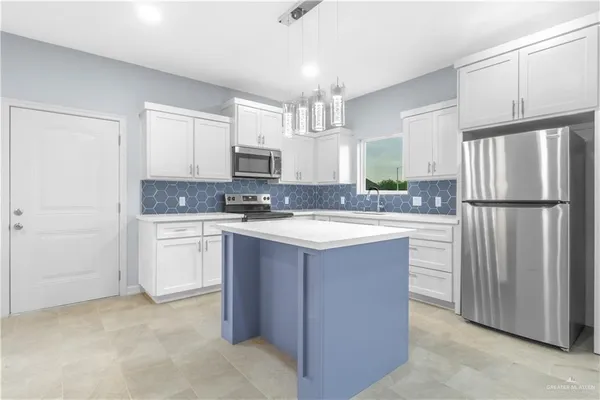 a kitchen with stainless steel appliances granite countertop a refrigerator sink and cabinets