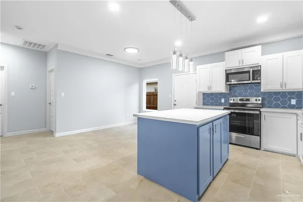 a kitchen with stainless steel appliances granite countertop a stove top oven and sink