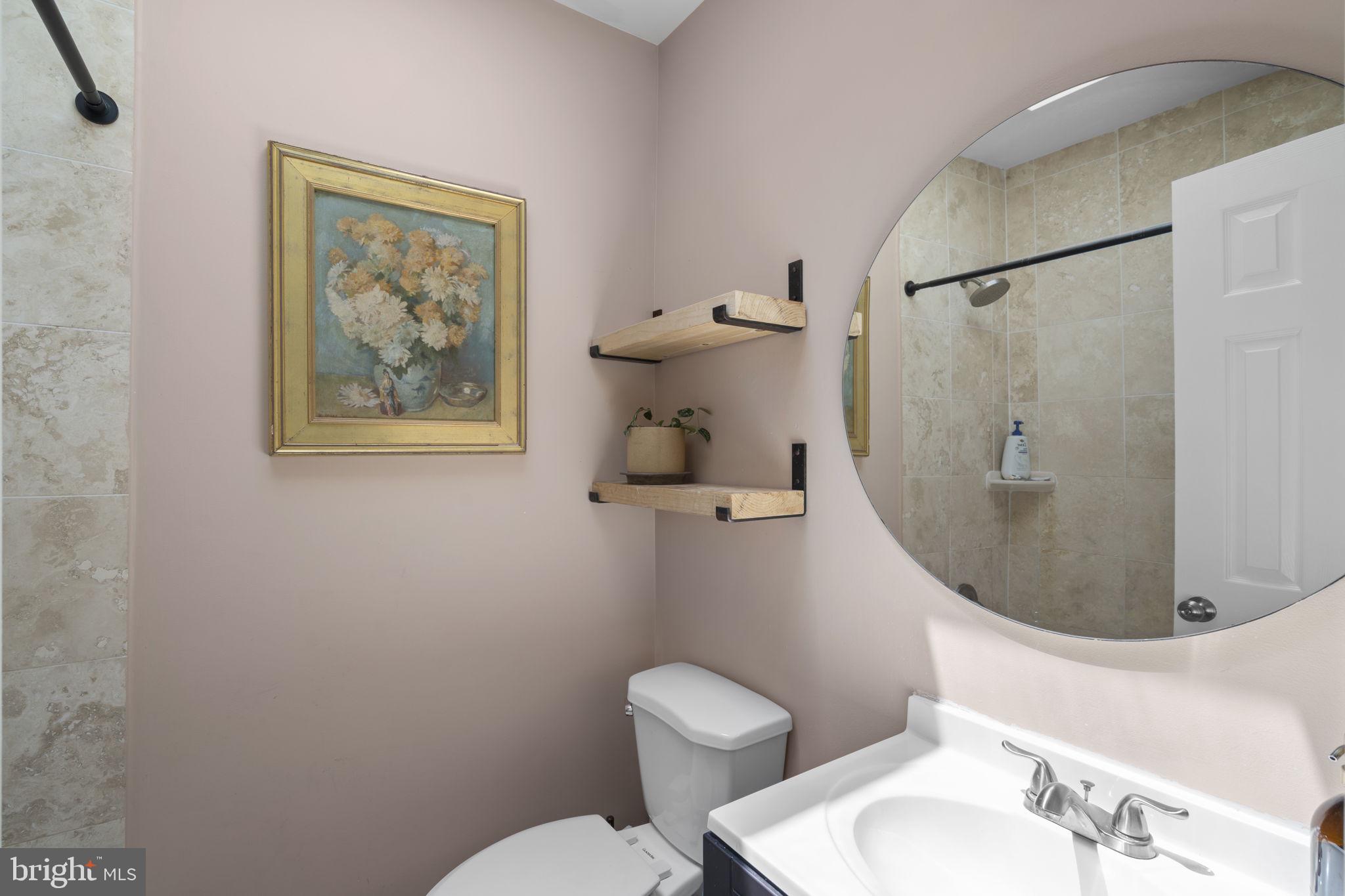 1712 M Street Northeast Washington, DC 20002 - Photo 16 of 38 a bathroom with a toilet sink and mirror