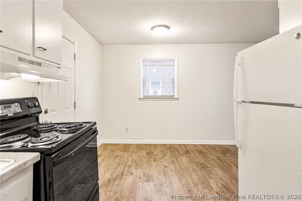 a kitchen with a stove and a refrigerator