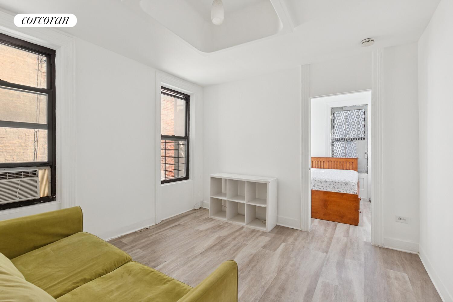 3692 Broadway, Unit 24 Manhattan, NY 10031 - Photo 2 of 6 a bedroom with natural light and wooden floor