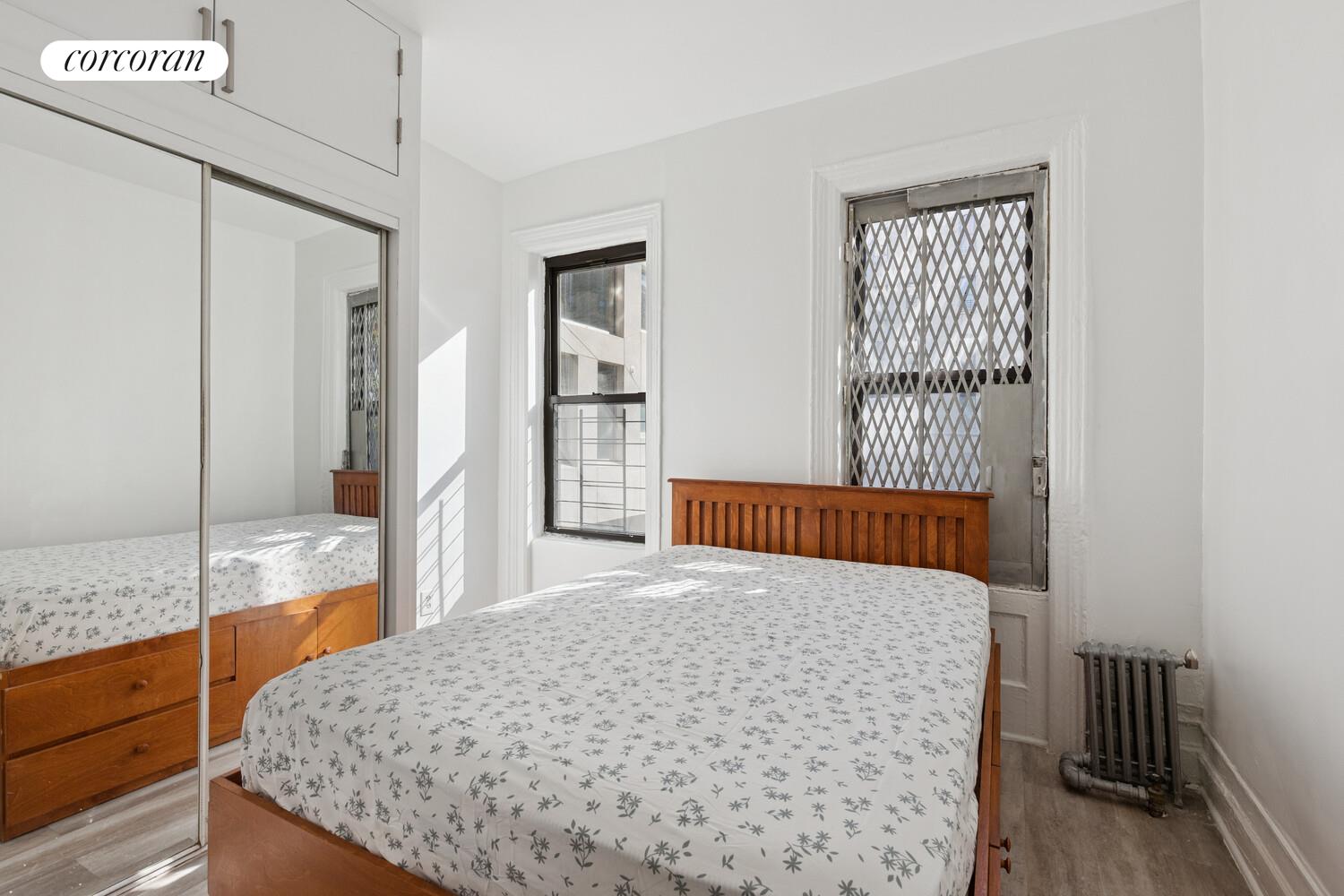 3692 Broadway, Unit 24 Manhattan, NY 10031 - Photo 3 of 6 a bedroom with a bed and a window with the outer view