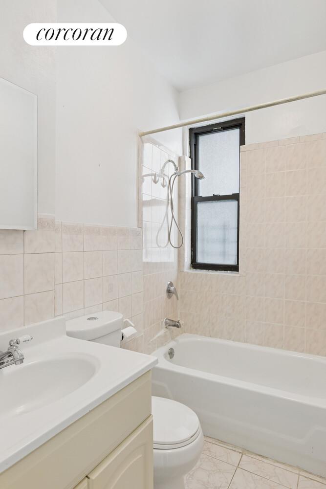 3692 Broadway, Unit 24 Manhattan, NY 10031 - Photo 5 of 6 a bathroom with a sink a toilet and a bathtub