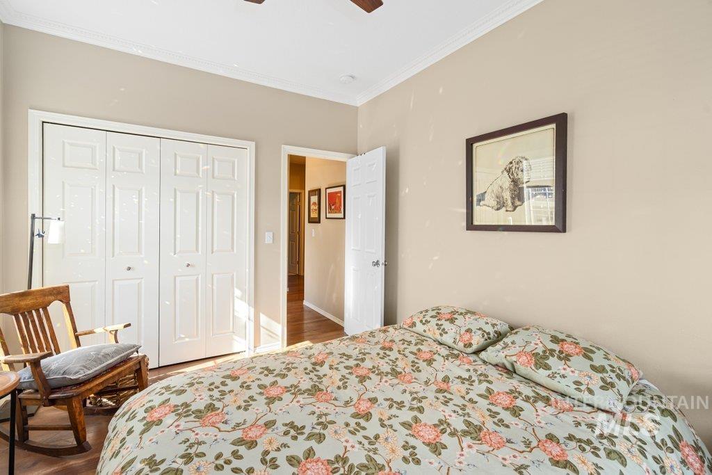 865 Fairview Drive Moscow, ID 83843 - Photo 23 of 50 Bedroom with ornamental molding, a closet, wood finished floors, and a ceiling fan