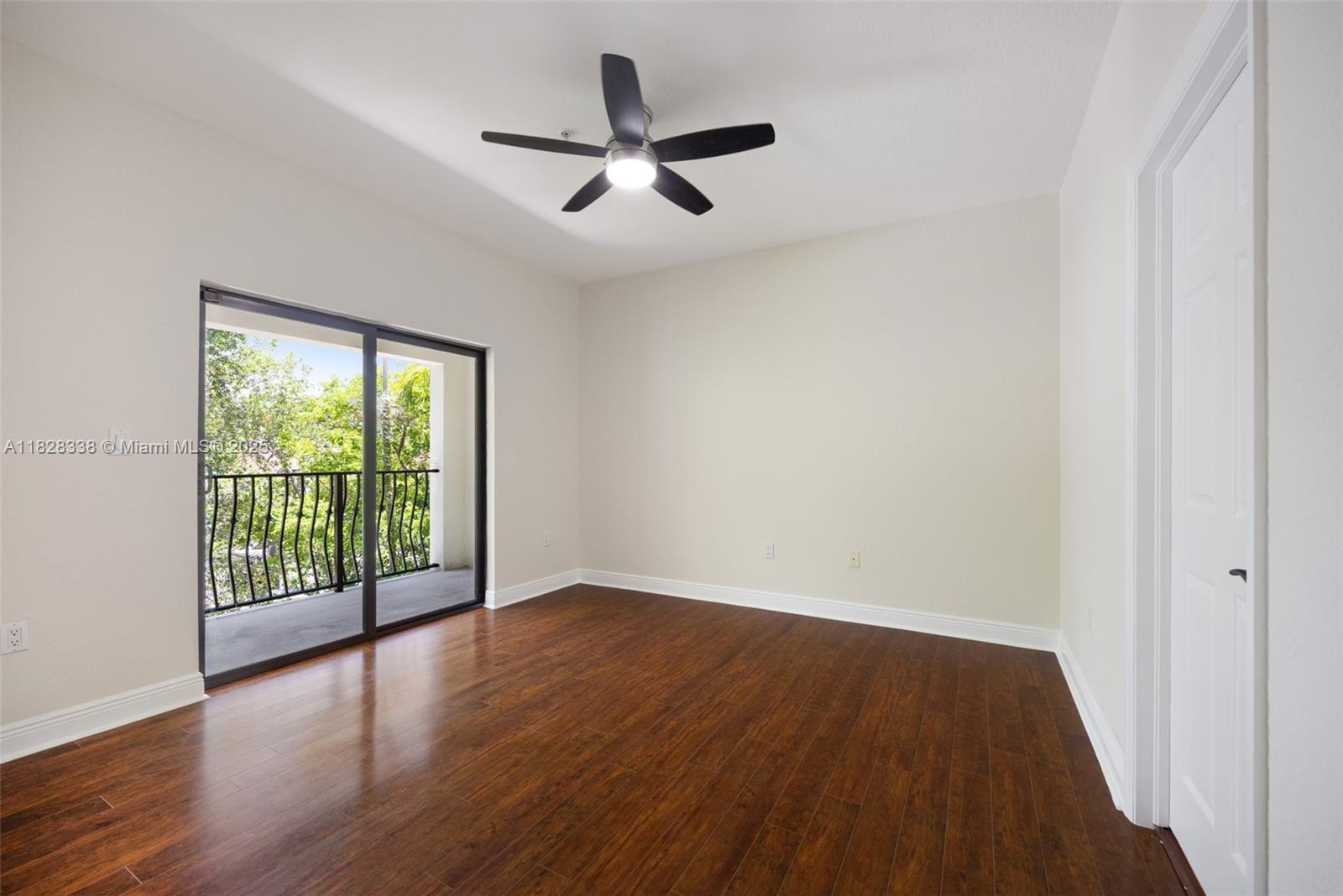 3204 Bird Avenue, Unit 108 Coconut Grove, FL 33133 - Photo 11 of 19 an empty room with wooden floor and windows