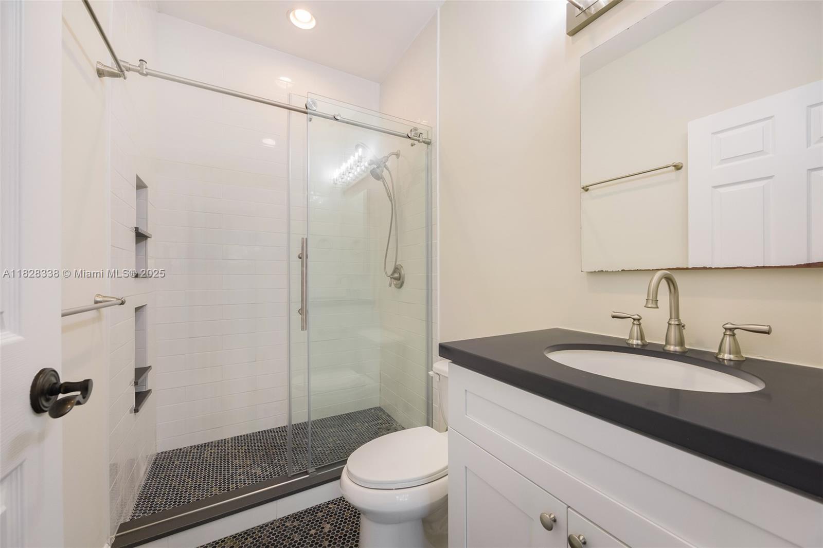 3204 Bird Avenue, Unit 108 Coconut Grove, FL 33133 - Photo 12 of 19 a bathroom with a sink toilet and shower