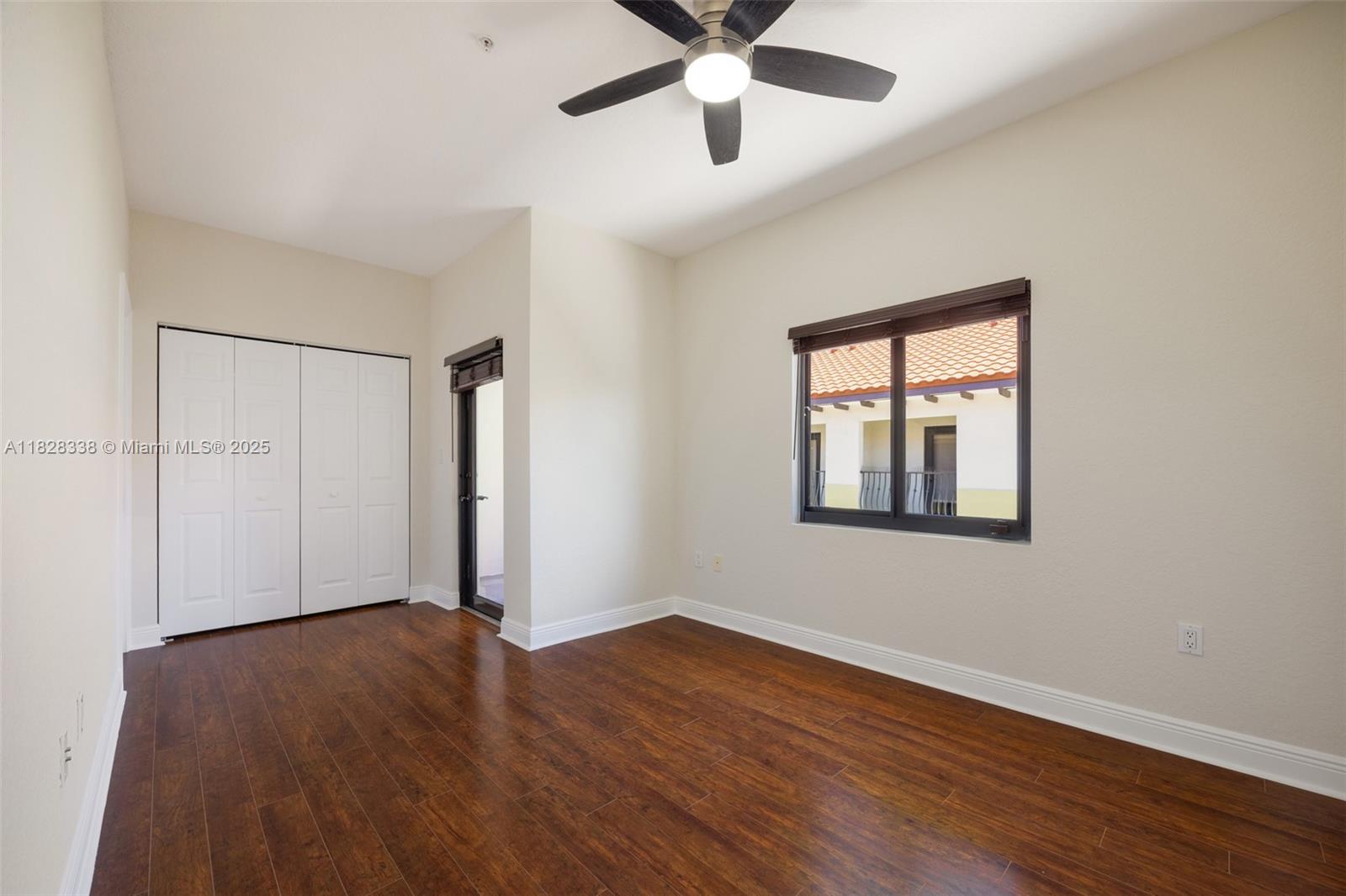 3204 Bird Avenue, Unit 108 Coconut Grove, FL 33133 - Photo 13 of 19 a view of an empty room with wooden floor and a window