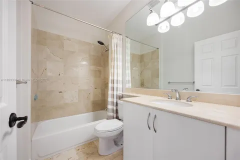 a bathroom with a sink vanity mirror and toilet