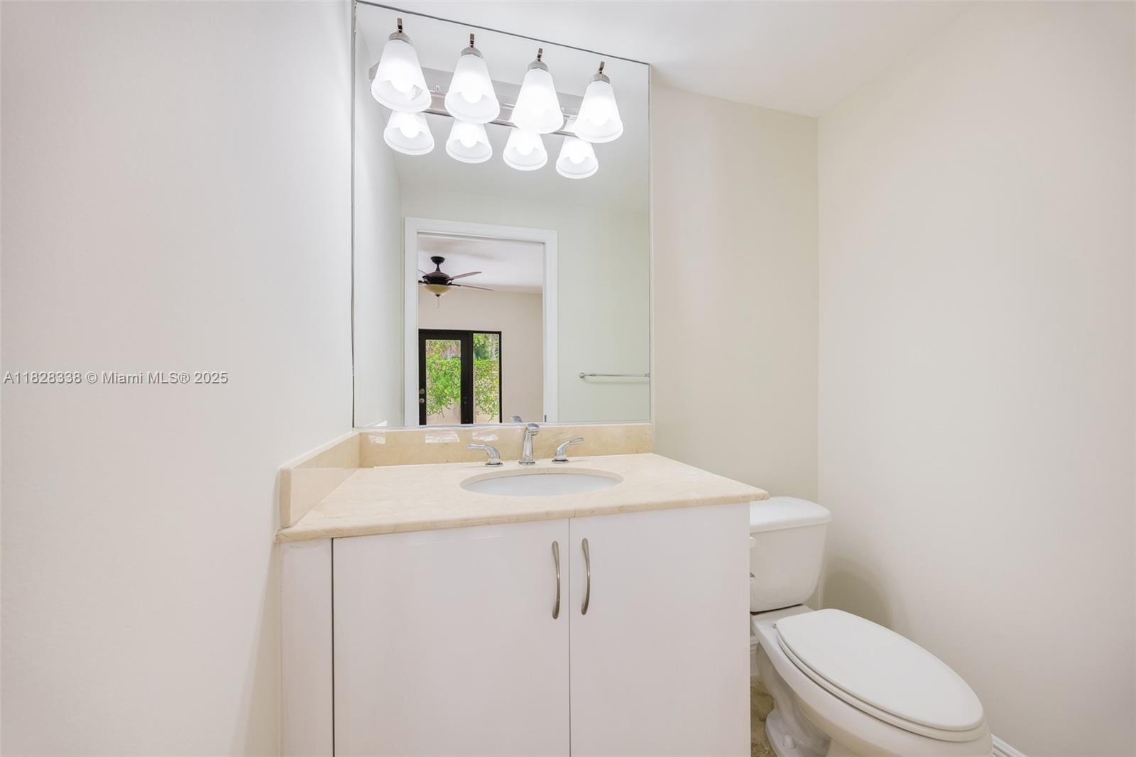 3204 Bird Avenue, Unit 108 Coconut Grove, FL 33133 - Photo 15 of 19 a bathroom with a sink vanity mirror and toilet