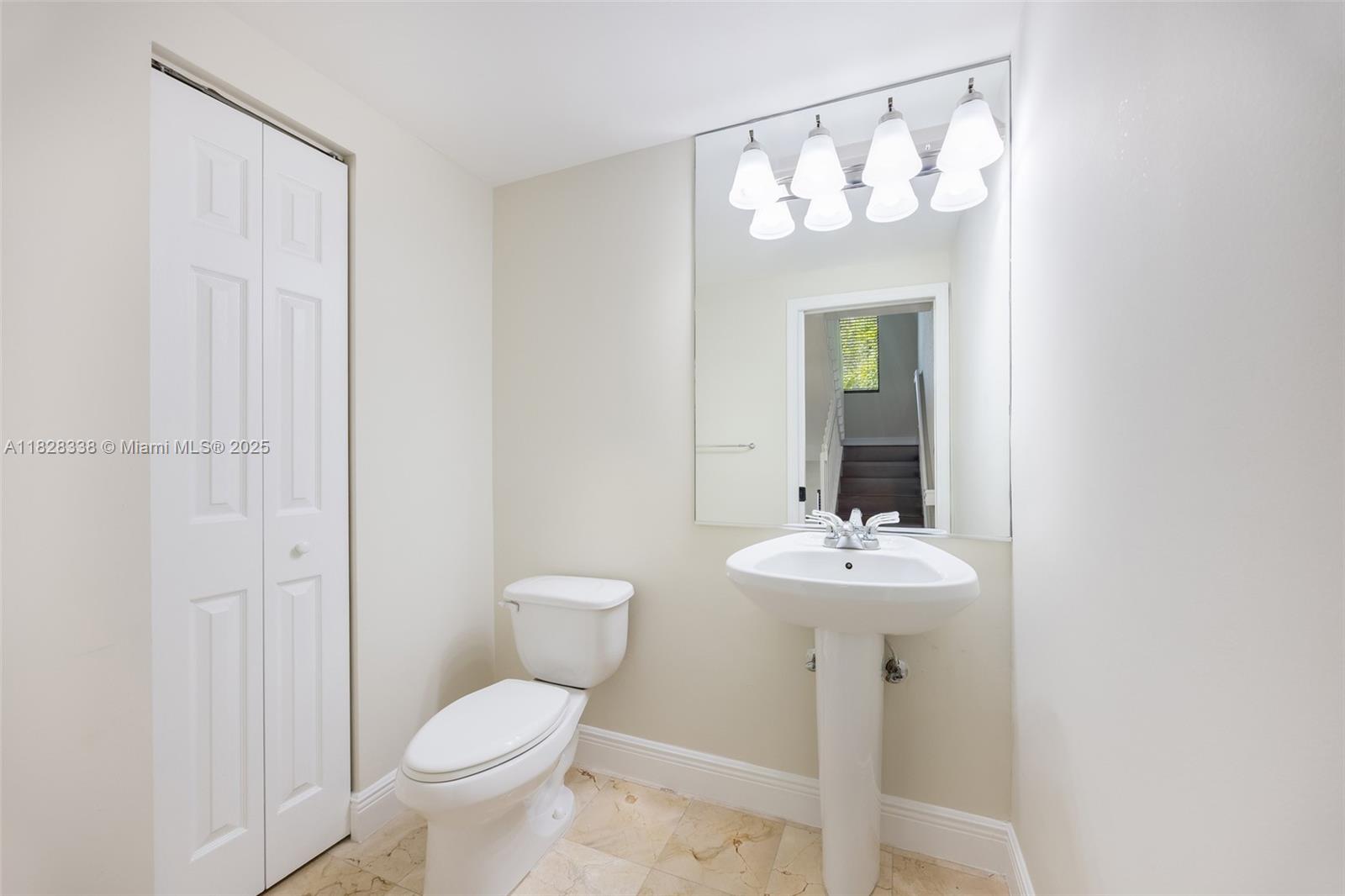 3204 Bird Avenue, Unit 108 Coconut Grove, FL 33133 - Photo 16 of 19 a bathroom with a toilet sink and mirror