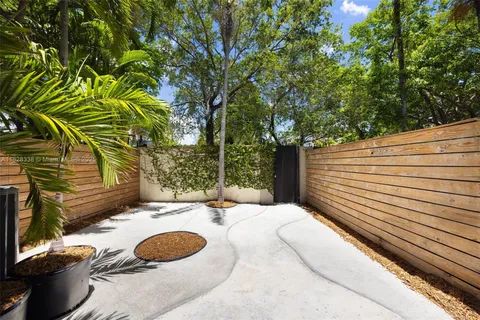 a view of a patio with table and chairs with wooden floor and fence