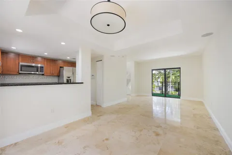 a kitchen with stainless steel appliances granite countertop a sink stove and microwave