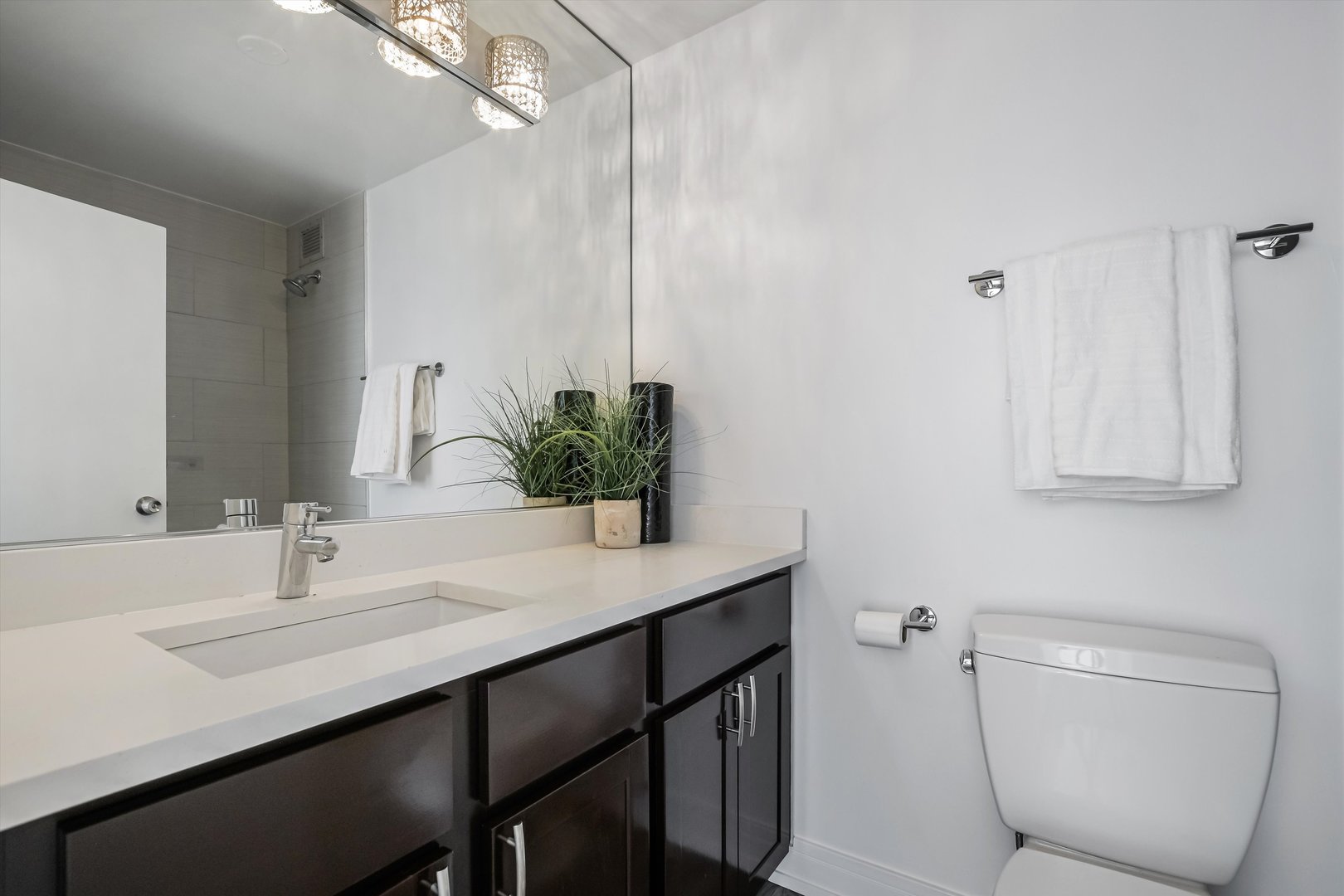 3930 North Pine Grove Avenue, Unit 2308 Chicago, IL 60613 - Photo 14 of 29 a bathroom with a toilet a sink and mirror