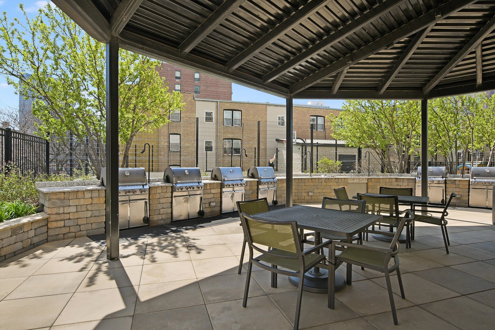 3930 North Pine Grove Avenue, Unit 2308 Chicago, IL 60613 - Photo 29 of 29 a patio with yard table and chairs
