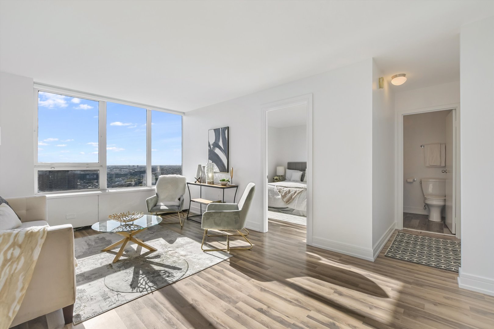 3930 North Pine Grove Avenue, Unit 2308 Chicago, IL 60613 - Photo 8 of 29 a living room with furniture and a floor to ceiling window
