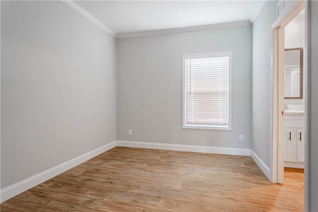 210 Ridge Road Seale, AL 36875 - Photo 14 of 16 Wood-finish flooring, white window blinds, and crown molding