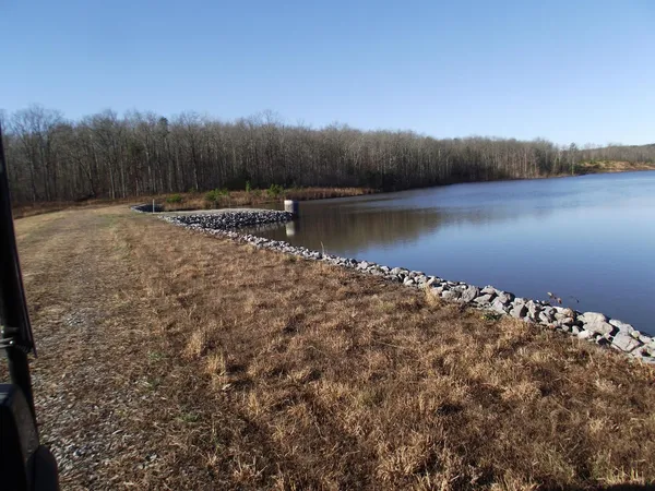 a view of a lake next to a yard