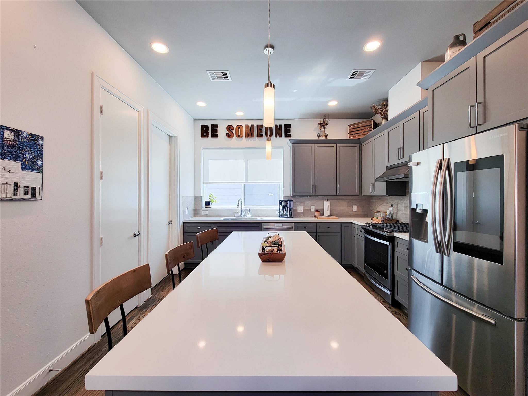 1705 Eado Point Lane Houston, TX 77003 - Photo 26 of 50 Modern kitchen with a large island, sleek stainless steel appliances, and ample cabinet space. Bright lighting and contemporary decor create a welcoming atmosphere.