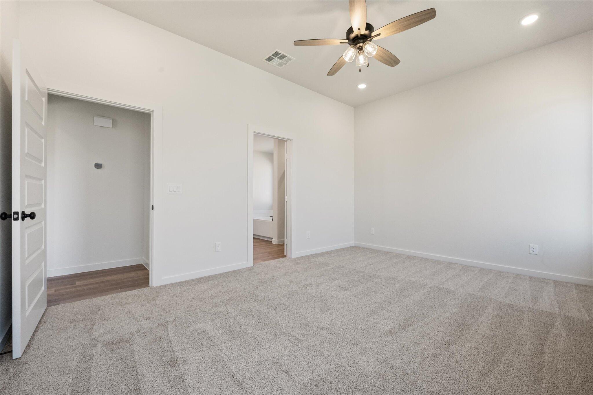 7003 53rd Street Lubbock, TX 79407 - Photo 15 of 25 an empty room with fan and a ceiling fan