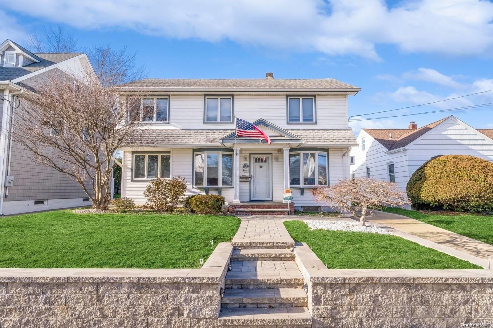a front view of house with yard and green space