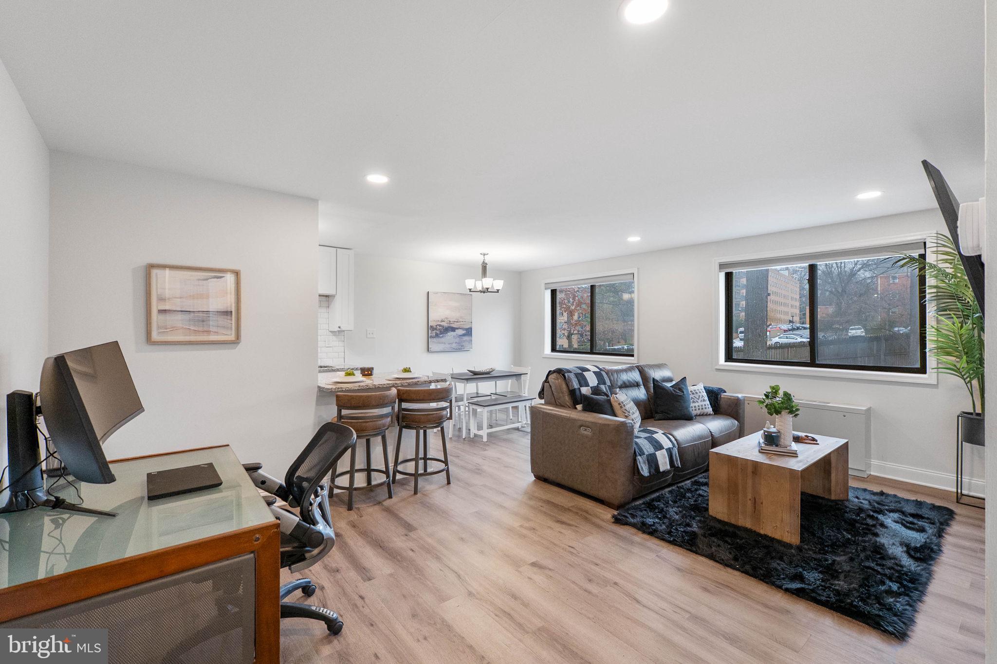 8601 Manchester Road, Unit 220 Silver Spring, MD 20901 - Photo 1 of 27 a living room with furniture and a wooden floor