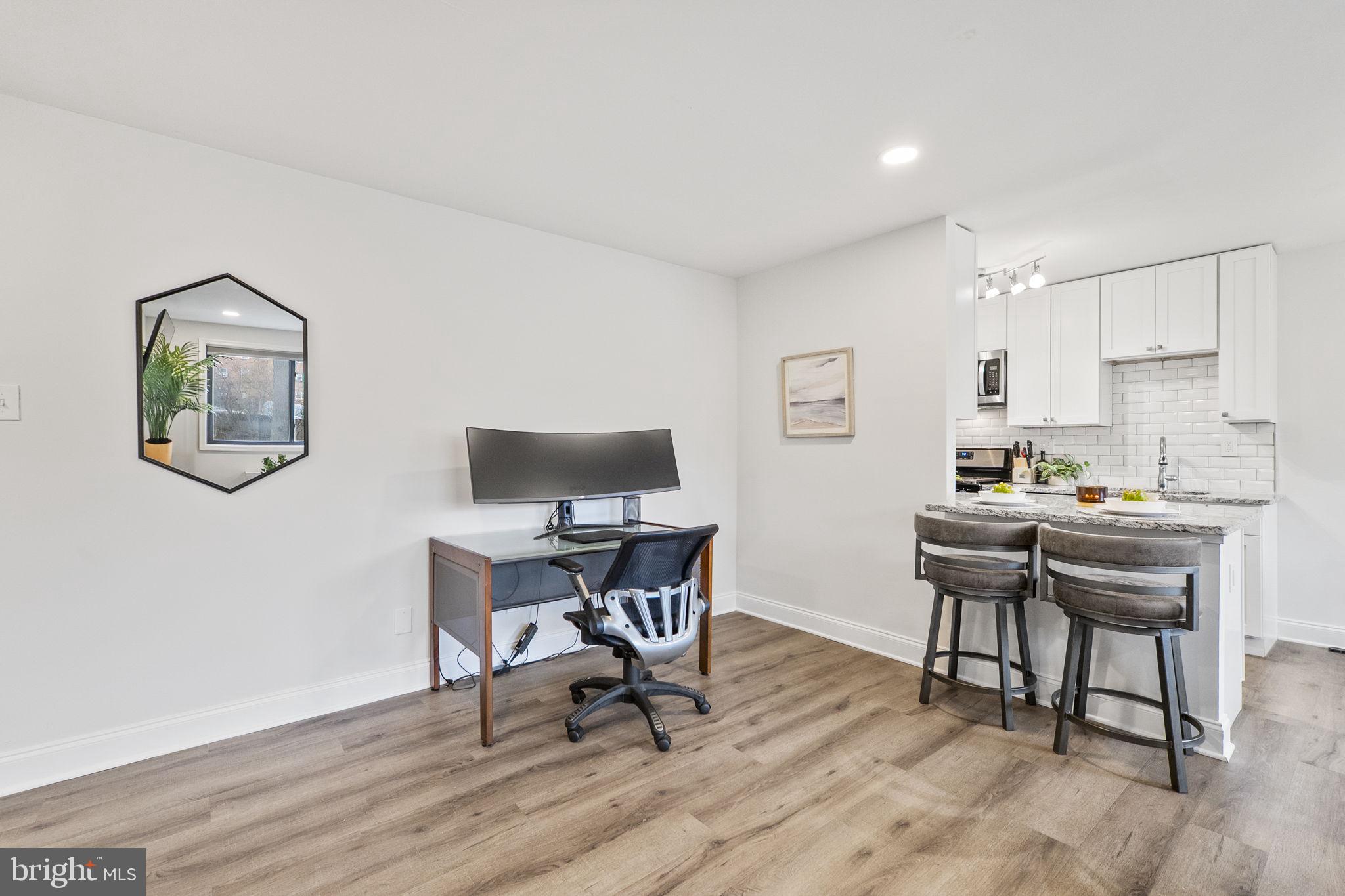 8601 Manchester Road, Unit 220 Silver Spring, MD 20901 - Photo 17 of 27 a workspace with furniture and wooden floor