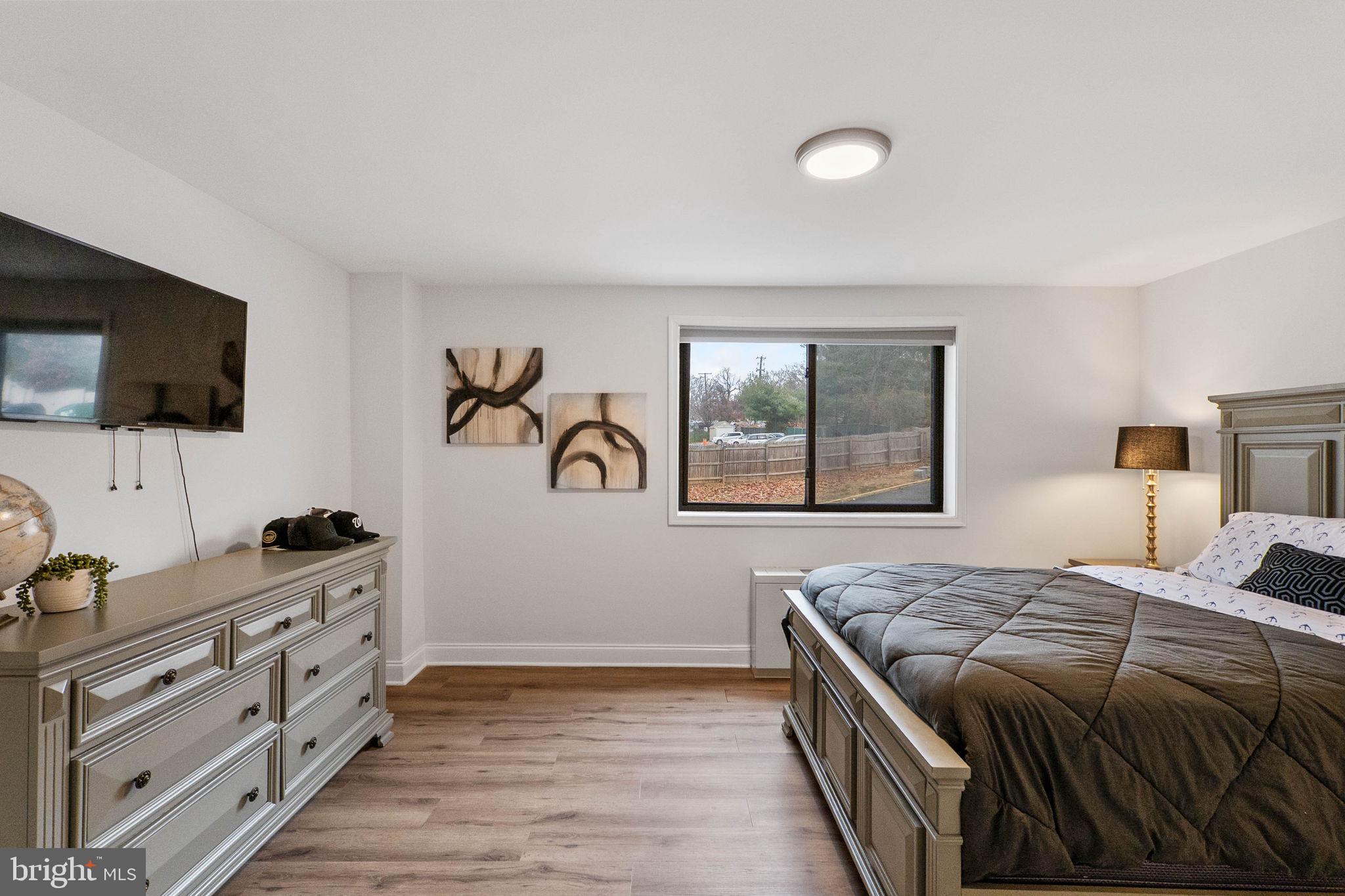 8601 Manchester Road, Unit 220 Silver Spring, MD 20901 - Photo 18 of 27 a bedroom with a bed and a flat screen tv