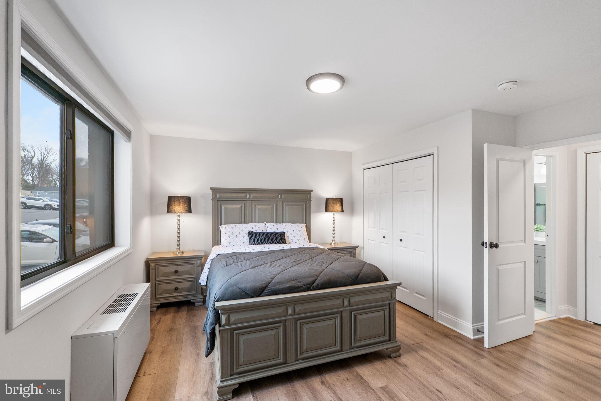 8601 Manchester Road, Unit 220 Silver Spring, MD 20901 - Photo 20 of 27 a bedroom with a bed and a large window