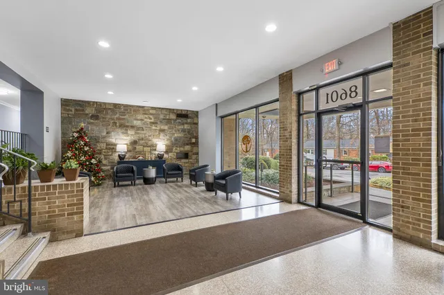 a lobby with furniture and floor to ceiling window