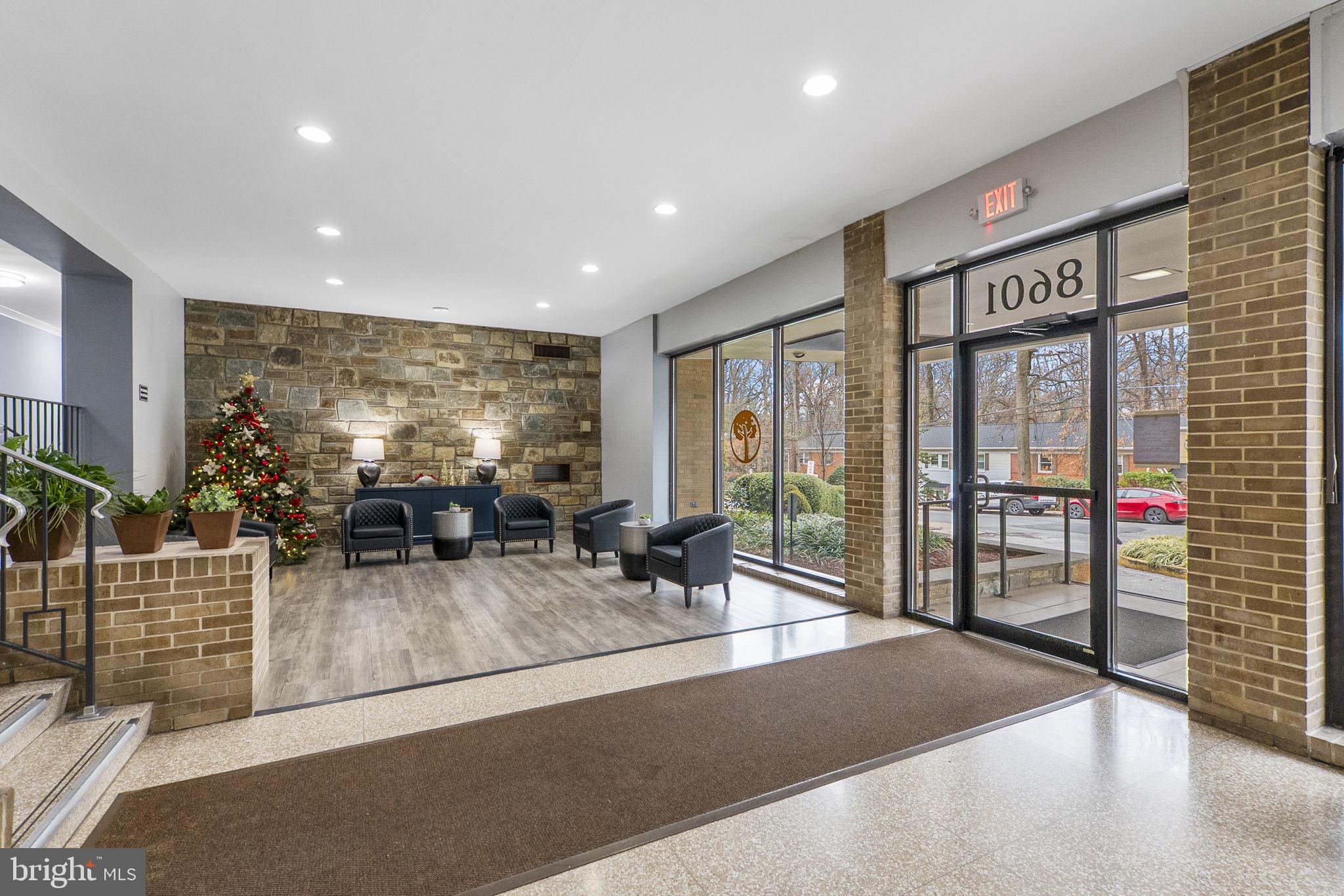 8601 Manchester Road, Unit 220 Silver Spring, MD 20901 - Photo 25 of 27 a lobby with furniture and floor to ceiling window