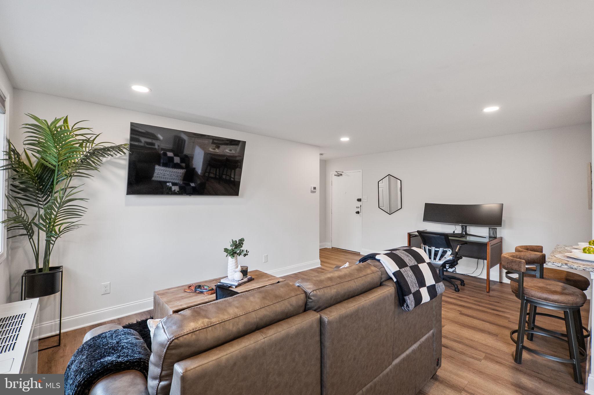 8601 Manchester Road, Unit 220 Silver Spring, MD 20901 - Photo 3 of 27 a living room with furniture and a flat screen tv