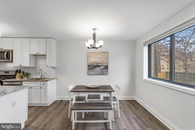 a kitchen with a stove a sink and cabinets