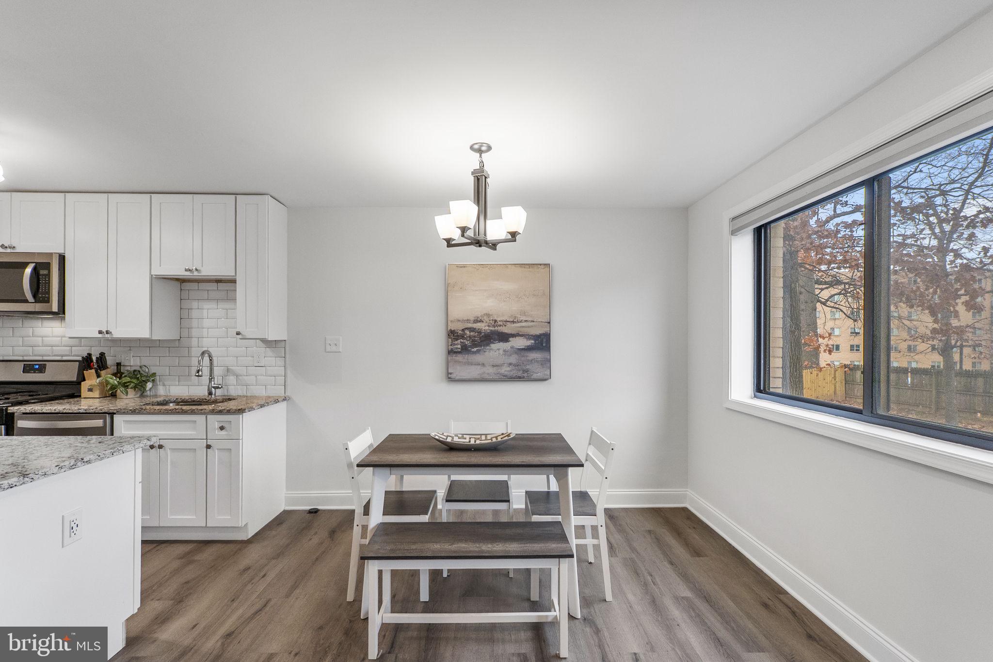8601 Manchester Road, Unit 220 Silver Spring, MD 20901 - Photo 10 of 27 a kitchen with a stove a sink and cabinets