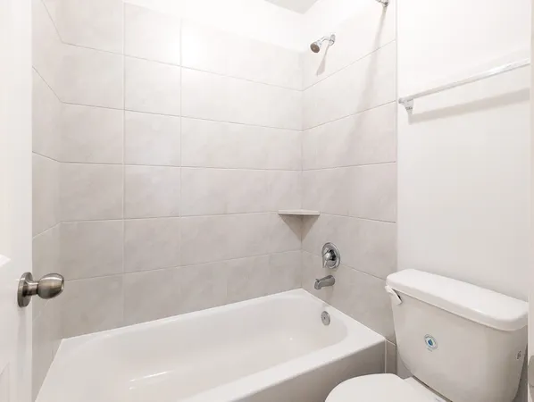 a bathroom with a bathtub and a toilet