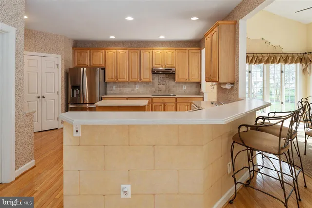 a kitchen with stainless steel appliances granite countertop a sink and a refrigerator