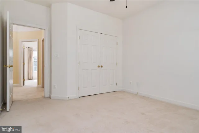 an empty room with windows and closet