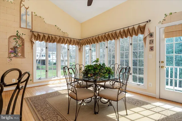 a dining room with furniture and a floor to ceiling window