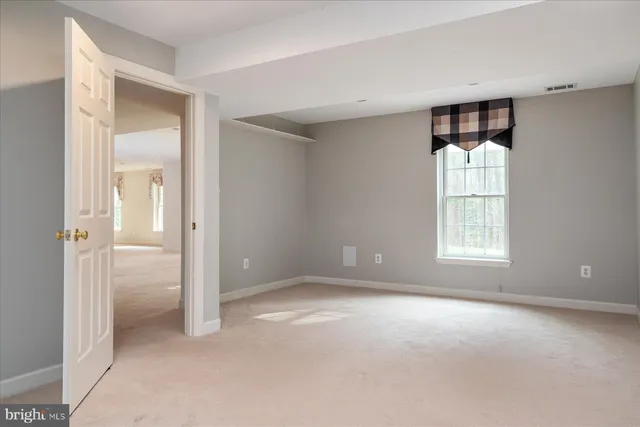 a view of a brick house with a yard and plants