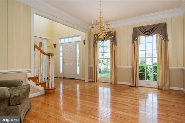 a view of a livingroom with furniture window wooden floor and front door