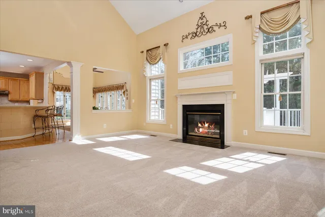 a view of a livingroom with a fireplace and workspace