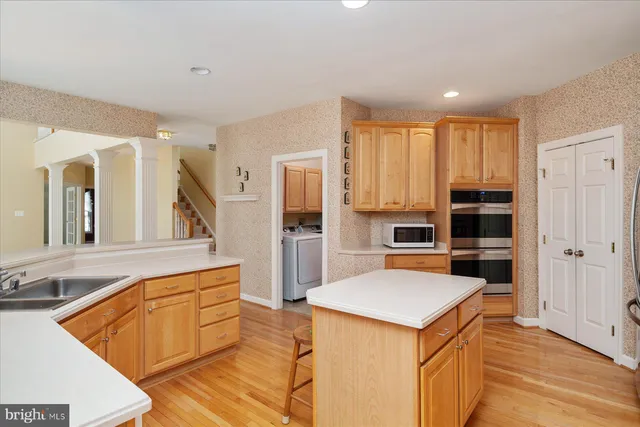 a view of kitchen with cabinets and wooden floor