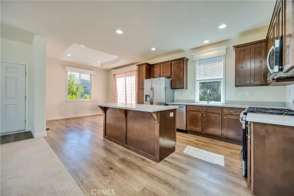 a kitchen with stainless steel appliances granite countertop a stove a sink and a refrigerator
