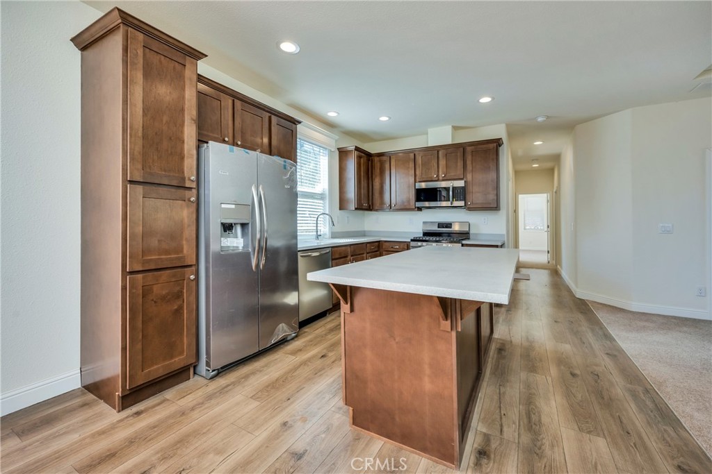 12299 Elk Mountain Road Upper Lake, CA 95485 - Photo 9 of 37 a kitchen with stainless steel appliances a refrigerator and a stove top oven
