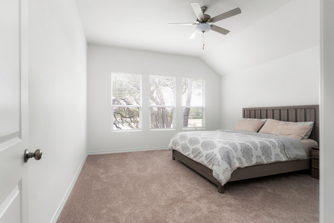 4264 Hill House Lane Georgetown, TX 78628 - Photo 12 of 30 Carpeted bedroom featuring a ceiling fan and vaulted ceiling