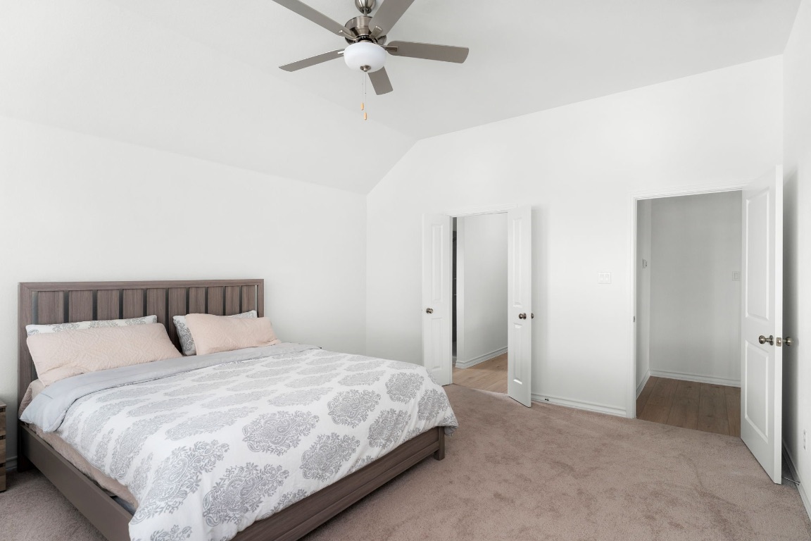 4264 Hill House Lane Georgetown, TX 78628 - Photo 13 of 30 Carpeted bedroom with a ceiling fan and lofted ceiling