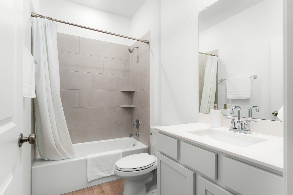 4264 Hill House Lane Georgetown, TX 78628 - Photo 25 of 30 Full bath featuring shower / bath combination with curtain, vanity, and light wood finished floors